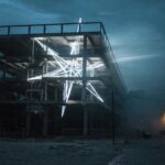 a monumental public art installation of a star shape made from LED strips inside of a concrete and steel building at night