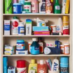 a paper mache sculpture of a medicine cabinet filled with over the counter medicines, prescriptions, and other bathroom goods