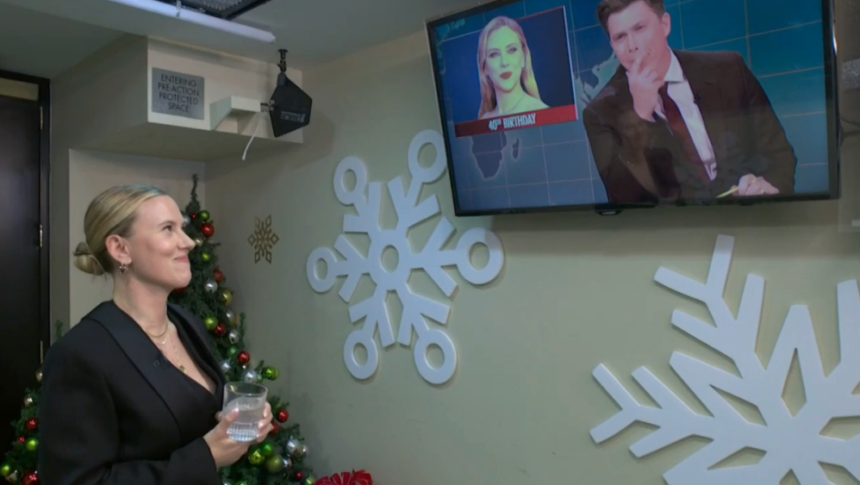 Colin Jost Tells Scarlett Johansson Jokes on Weekend Update As She Watches Backstage