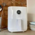 Clean white Xiaomi air fryer with kitchen accessories