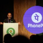 Sameer Nigam at podium with PhonePe logo shown