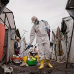 A worker spraying chlorine in Goma in the Democratic Republic of the Congo in August 2024