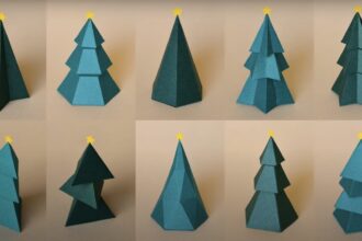 a screenshot from a video showing ten green, sculptural Christmas trees made from paper