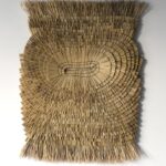 an abstract wall hanging made from rice straw