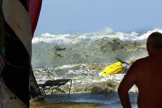 A tsunami approaches people on a coastline in Malaysia on December 26, 2004.