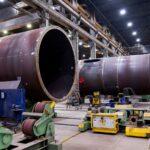 wind turbine towers under construction inside a plant