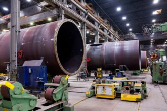 wind turbine towers under construction inside a plant