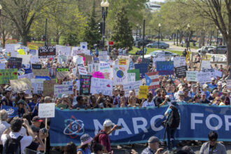 a crowd holding signs at the 2018 March for Science