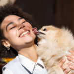 dog kissing human licking face