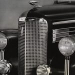 (Original Caption) 1938-Close-up of the very front end of a 1938 Cadillac La Salle. This smaller counterpart to the Cadillac features a smaller radiator grille, and four headlights, as well as the hood ornament and bumper.