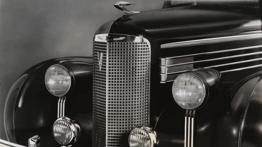 (Original Caption) 1938-Close-up of the very front end of a 1938 Cadillac La Salle. This smaller counterpart to the Cadillac features a smaller radiator grille, and four headlights, as well as the hood ornament and bumper.