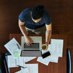 A man working at his desk seen from above.