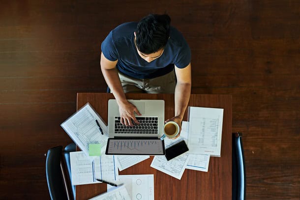 A man working at his desk seen from above.