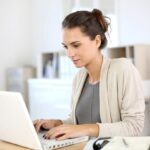 A woman working hard at her laptop.