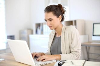 A woman working hard at her laptop.