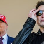 Elon Musk adjusts his sunglasses and Donald Trump looks on from two paces behind him. The two men are together to watch the launch of a SpaceX rocket.