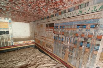 the interior of a kiln tomb in Saqqara of a doctor named Tetinebefou, with brightly colored walls and relief carvings in stone