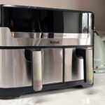 The air fryer on a kitchen counter, with a kettle in the background