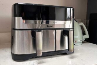 The air fryer on a kitchen counter, with a kettle in the background