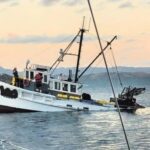 Two rescued as fishing boat sinks