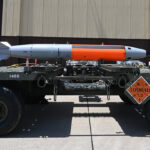 Military personnel are shown with a nuclear-capable weapons system during a test.