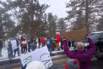 Protesters gather outside Rocky Mountain National Park to support federal workers