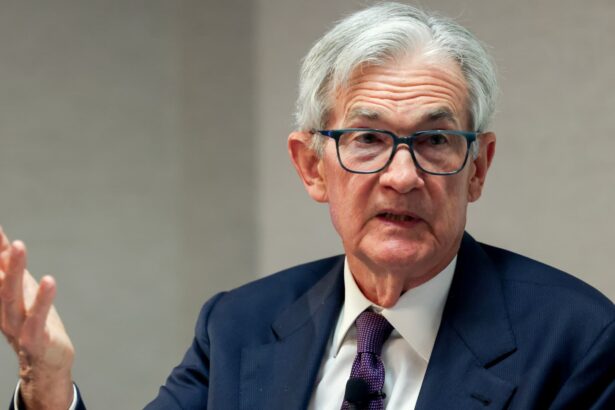 Powell sees tariffs raising inflation and says Fed will wait before further rate moves