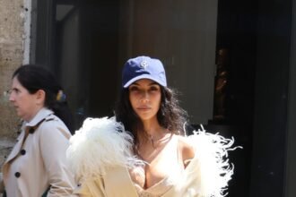 Kim Kardashian Pushes High-Low Dressing to the Extreme in Ostrich Feathers and a Baseball Cap
