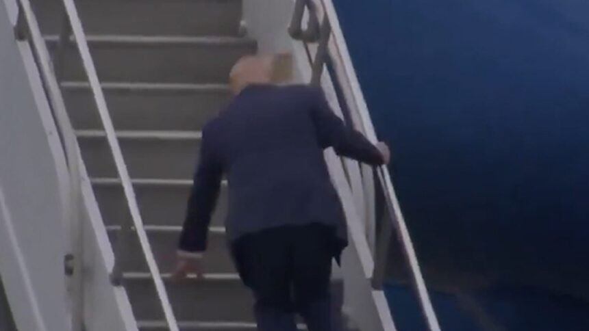 Donald Trump Trips Up The Steps Of Air Force One