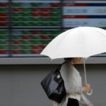 Shares advance, oil prices settle sharply lower as markets shrug off Iran conflict
