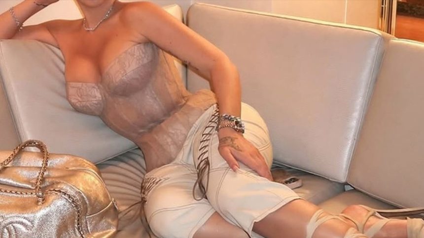 Guess The Sexy Singer Tied Up In This Corset!
