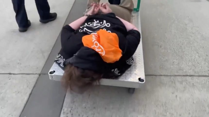 ICE posts viral video of cuffed Portland protester being wheeled away on flatbed cart