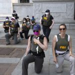 FBI agents sue after being fired for kneeling during racial justice protest : NPR