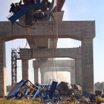 A construction crane falls onto a moving train in Thailand : NPR