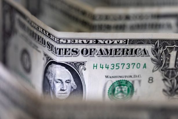 Dollar sinks to four-year low, Trump brushes off the decline