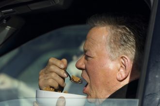 William Shatner Photographed Eating Bowl of Cereal in His Car at Stop Light