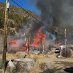 Brush fire sparks along I-70 in Colorado from house engulfed in flames