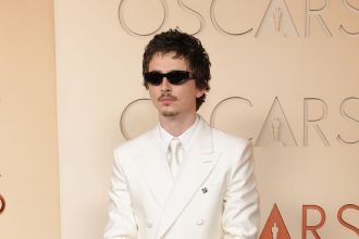 Timothée Chalamet Goes Full Y2K Boy Band in a White Suit and Goatee on the 2026 Oscars Red Carpet