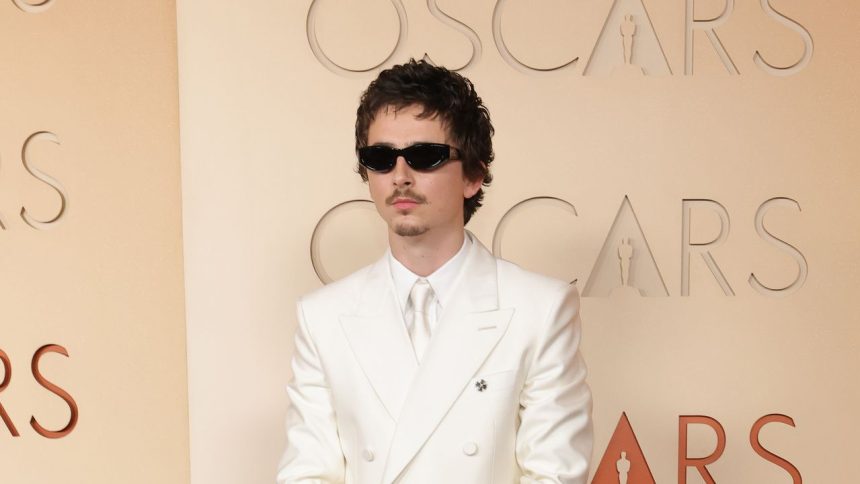 Timothée Chalamet Goes Full Y2K Boy Band in a White Suit and Goatee on the 2026 Oscars Red Carpet