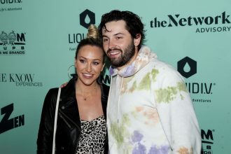 Baker Mayfield’s wife Emily shows off physical strength lifting heavy chest press with huge baby belly as due date nears