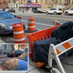 NYC parking wars has drivers saving parking spots with cones, Con Ed barriers and even derelict e-bikes