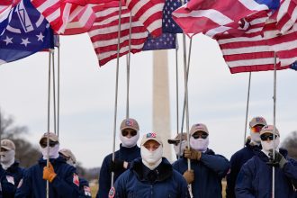 Demonstrators in white supremacist attire protest on Capitol Hill
